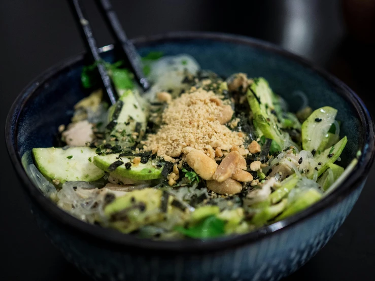 a bowl of broccoli sitting on top of a table