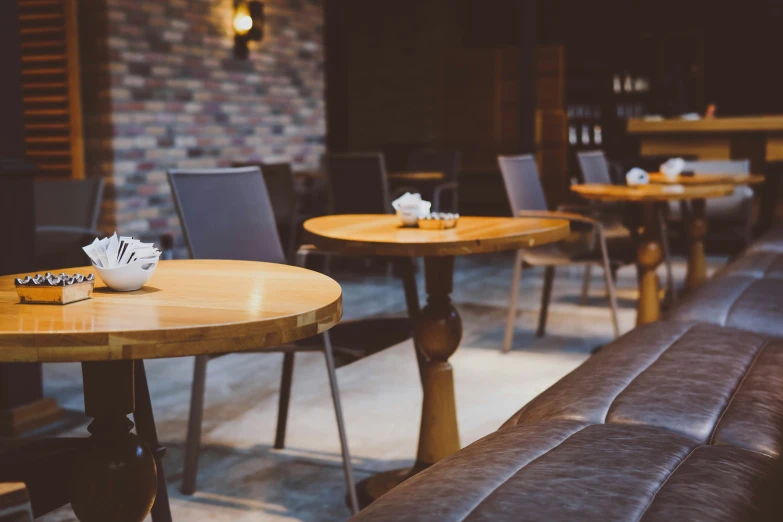 three round tables with chairs sitting in a bar