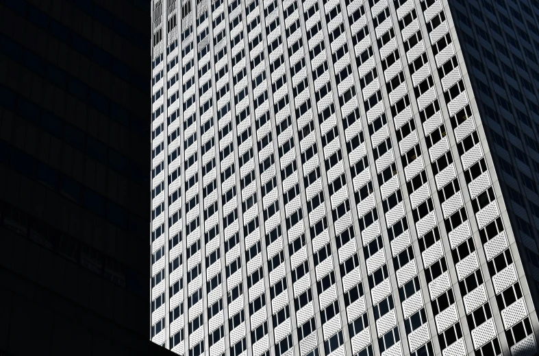 a very tall building with some black glass windows