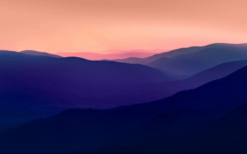 the sky over a valley of hills and trees