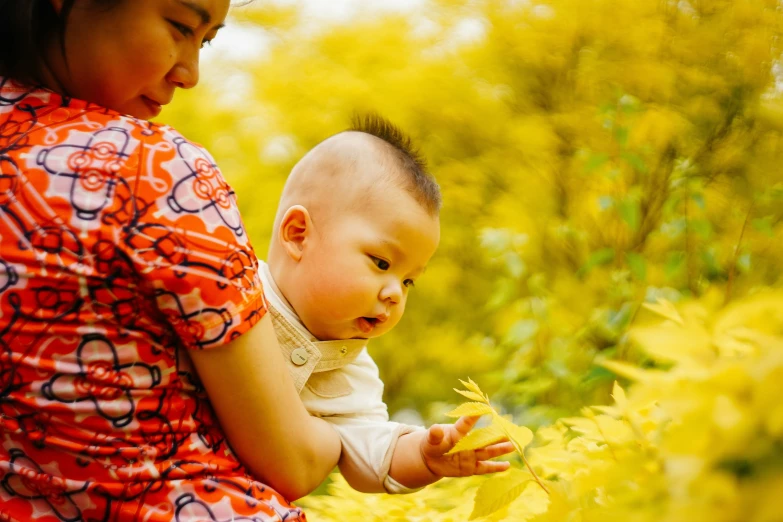 two children are playing outside and one is holding onto the other