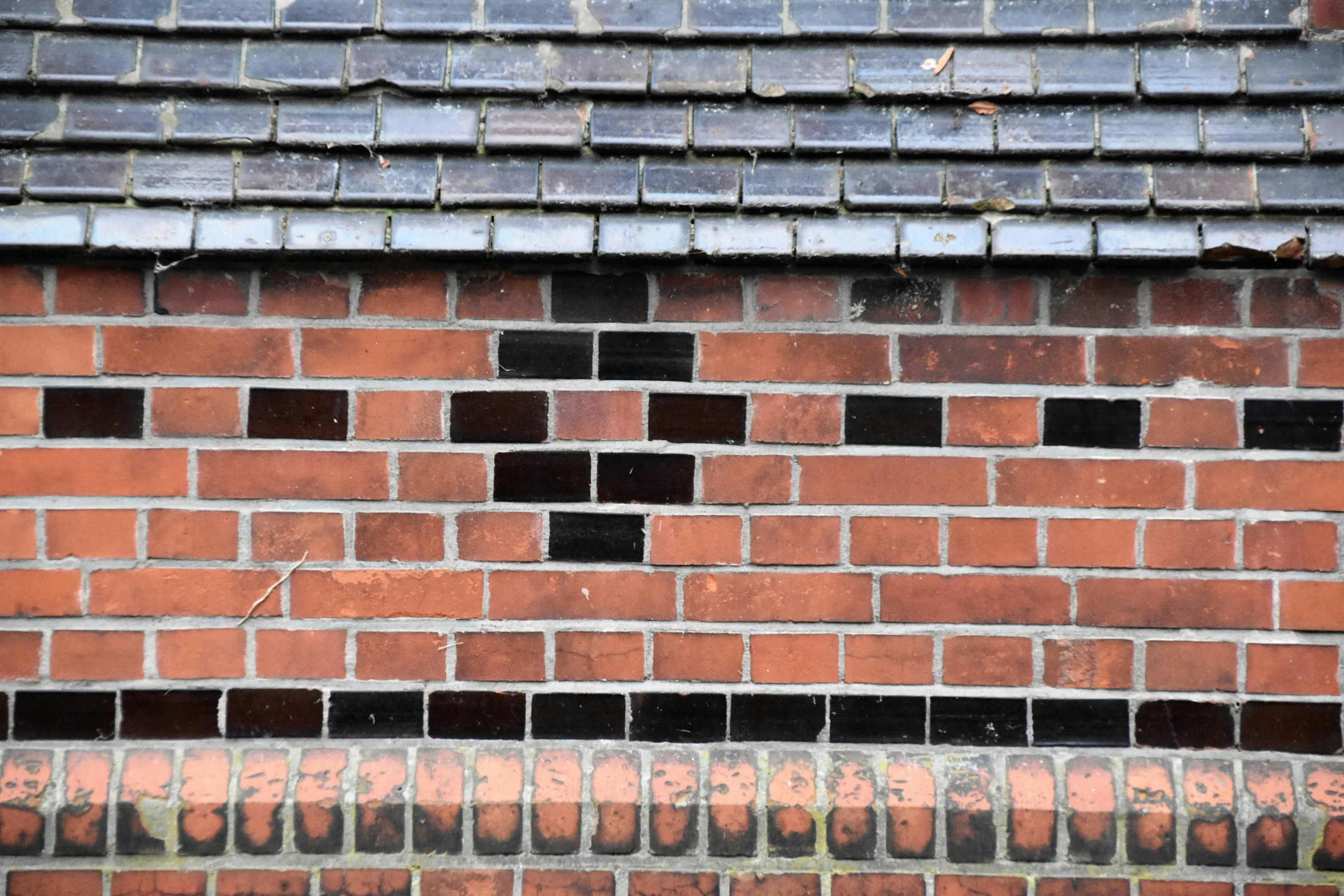 a brick building that is painted red and black