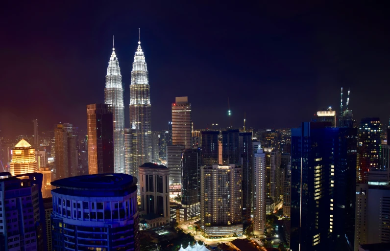 the city skyline at night lit up with lights