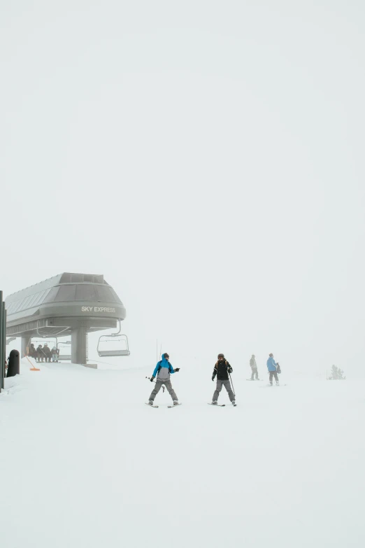 people cross country skiing in a foggy weather