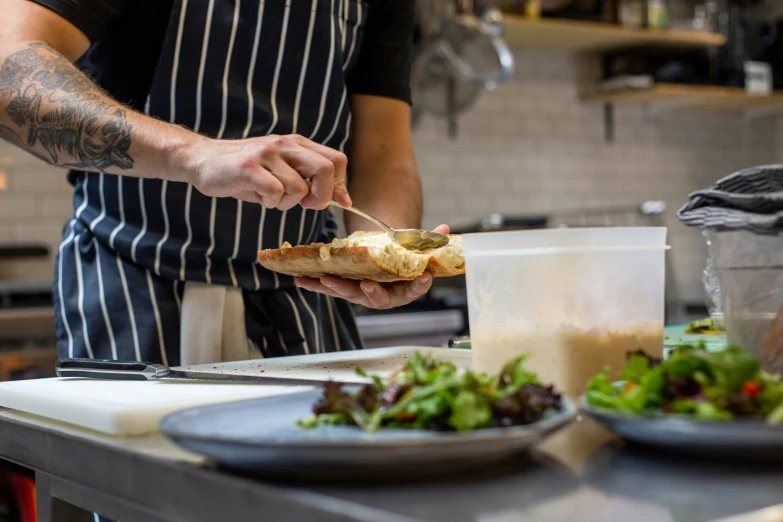 a man in a kitchen preparing food for a person