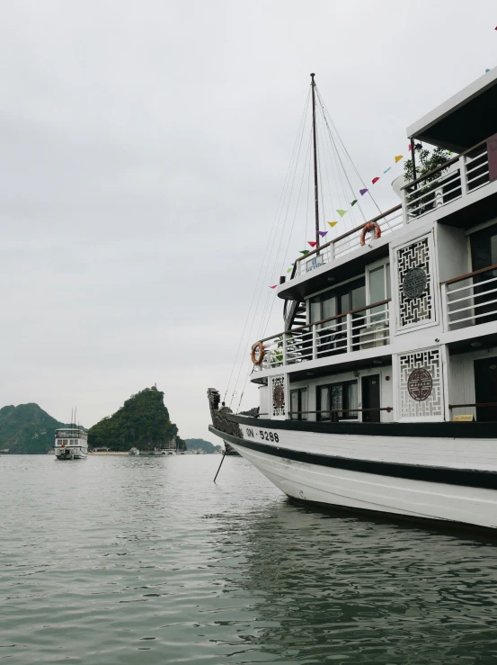 two boats are parked near each other in the water