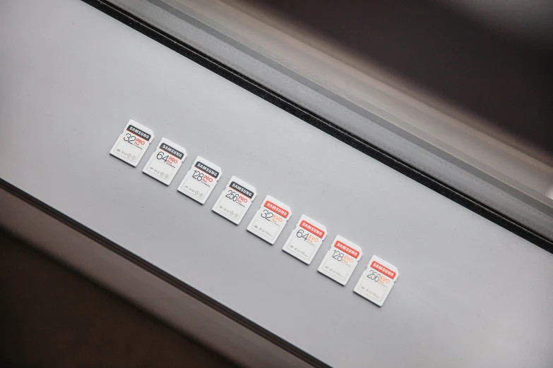 four tags are stuck on a metal drawer