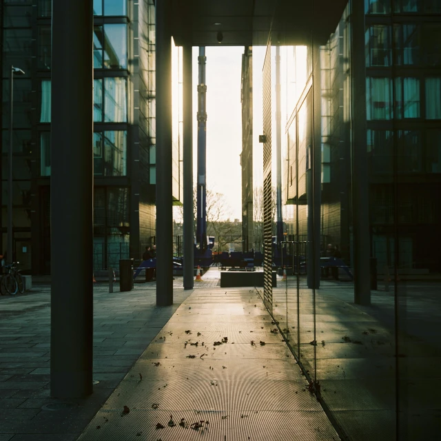 a long walkway with several buildings in the background