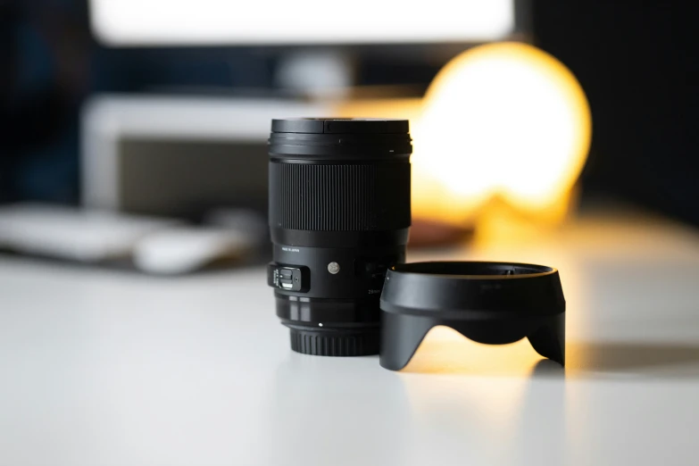 two cameras on a desk with the lens to the left