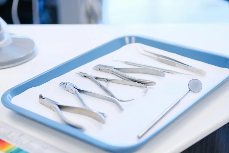 several surgical instruments placed on a tray ready to be used