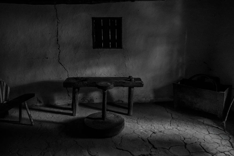 an empty room with two chairs and a table in the corner