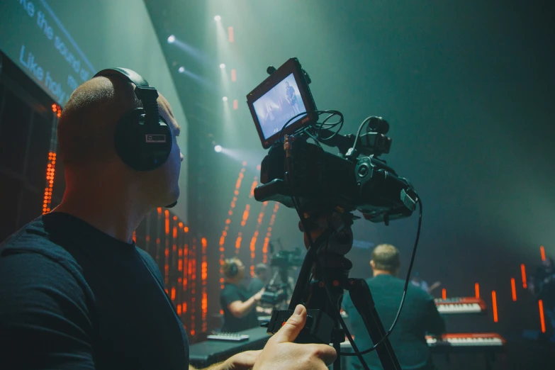 a cameraman recording a movie at a concert