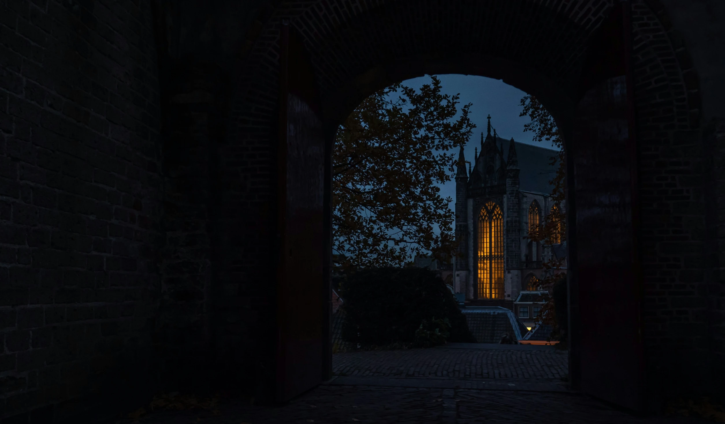 a church in a bricked building with a bright light at night