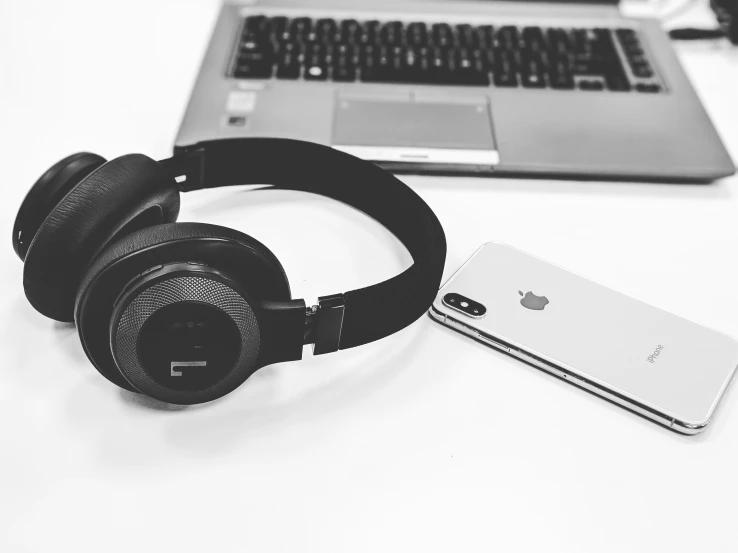 an image of headphones and laptop with one note