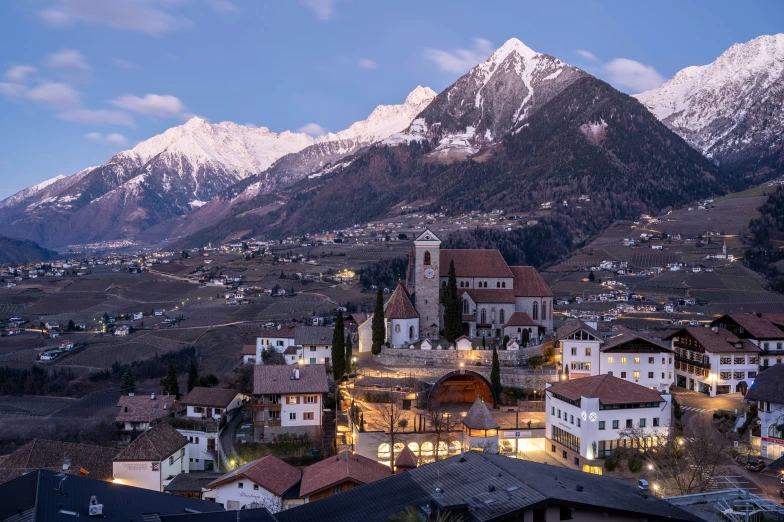 a city at night with mountains in the background