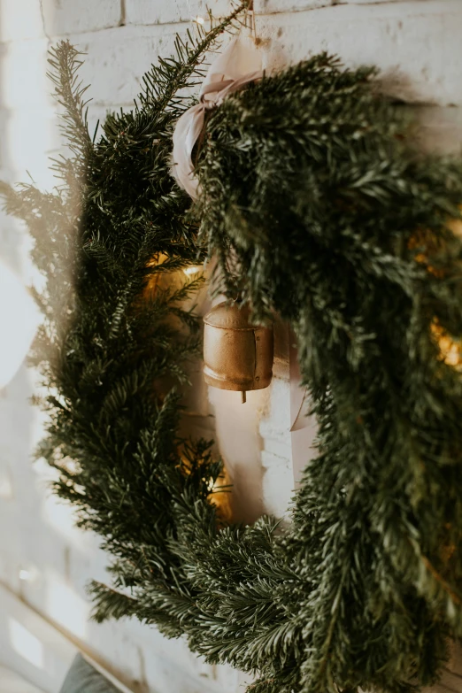 a christmas wreath is hung up near the fire place