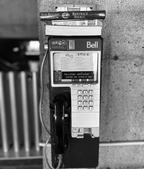 an old time pay phone is plugged up