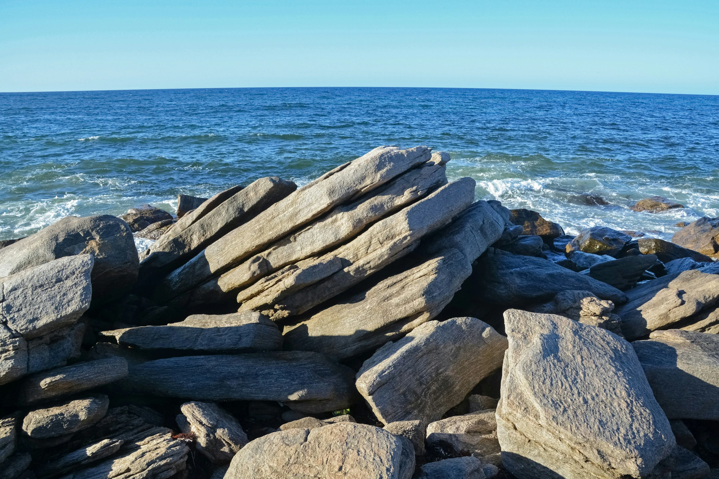 a close - up image of rocks and the ocean