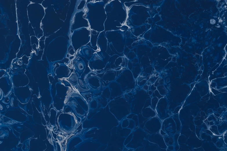 a marble tile with blue swirls is seen here