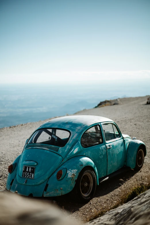 the old vw bug has been painted turquoise