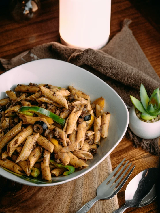 a bowl filled with pasta, beans, and other food