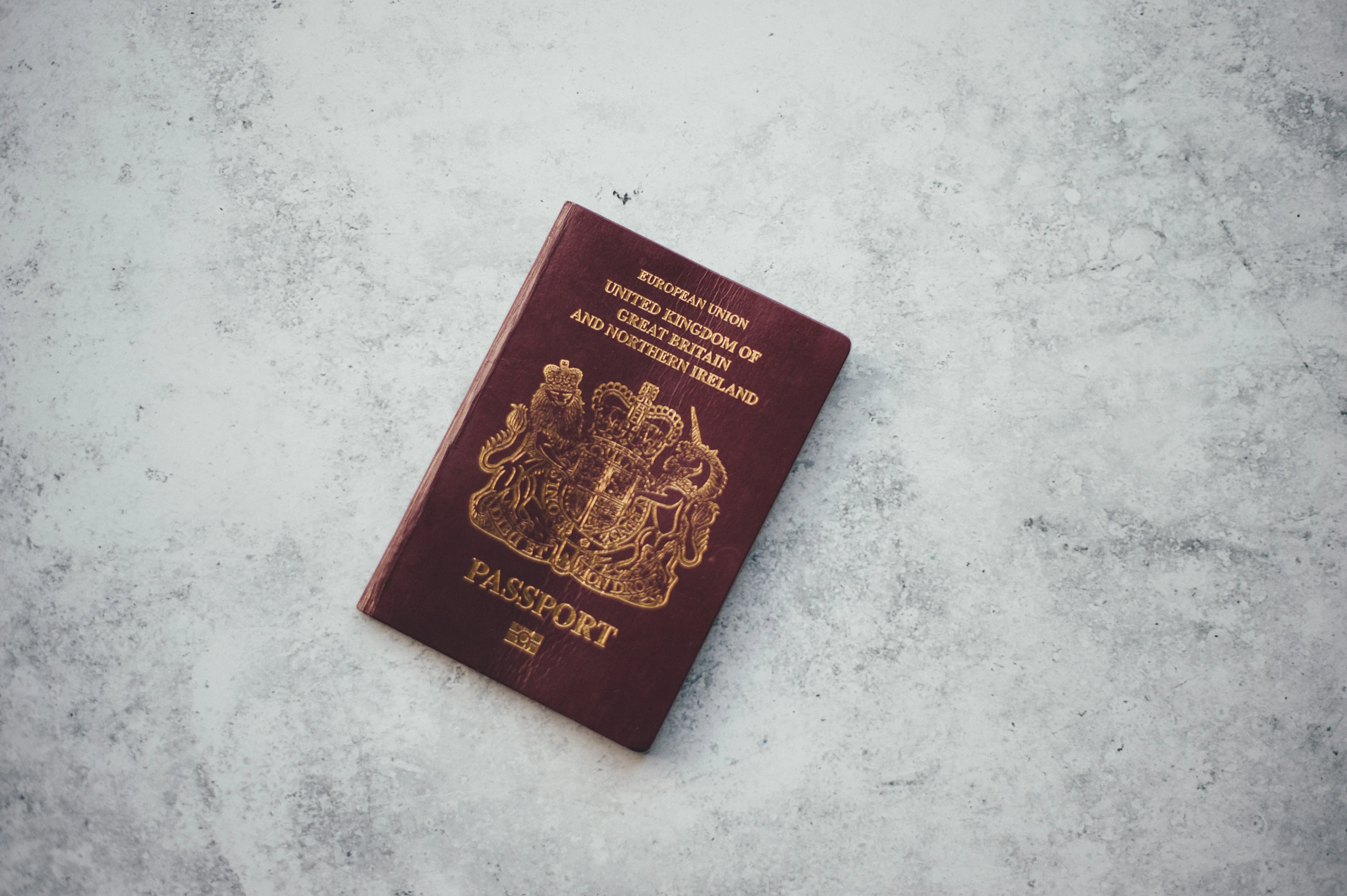 a british passport on a white table top