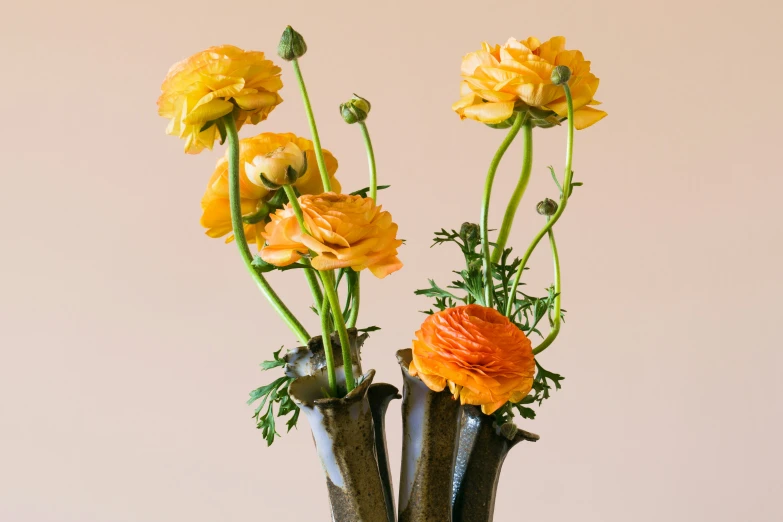 three different vases with different types of flowers in them