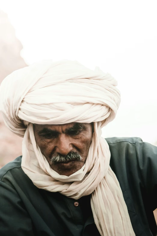 an old man with a turban and a beard