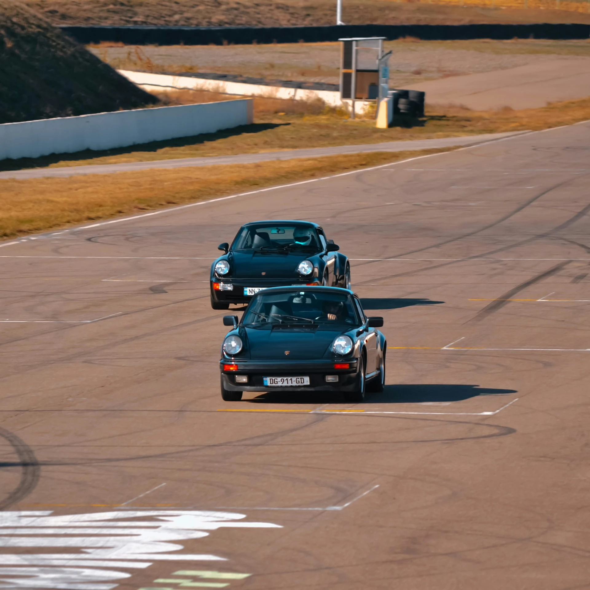 two small vehicles driving on a race track