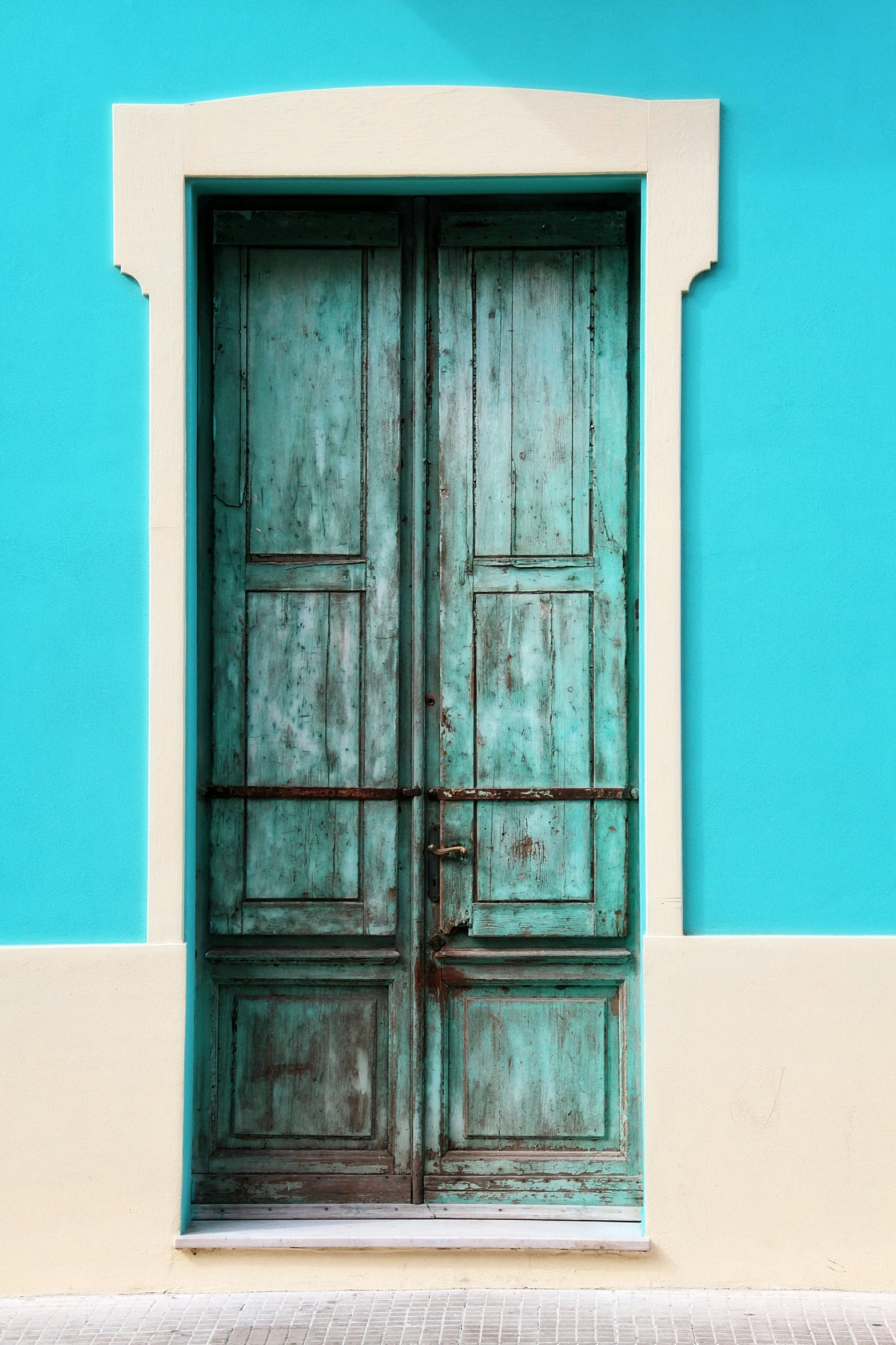 a blue and white building with a brown door