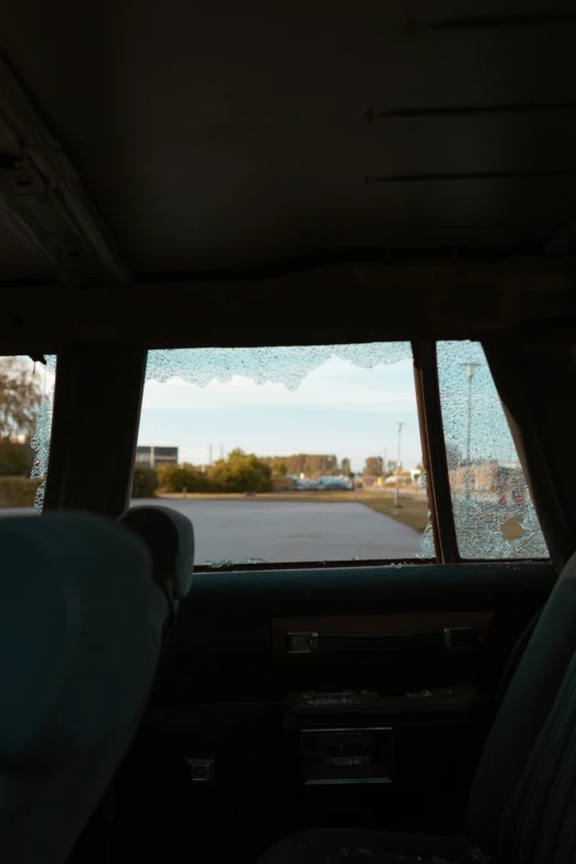 inside a car with several cars parked in the distance