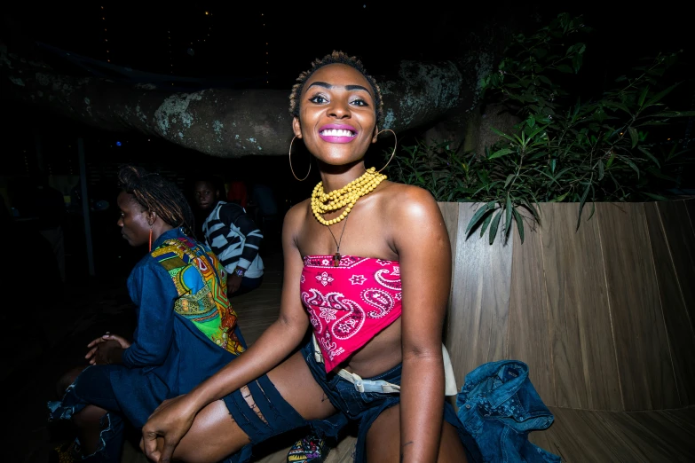 a young lady wearing sandals and necklace smiling