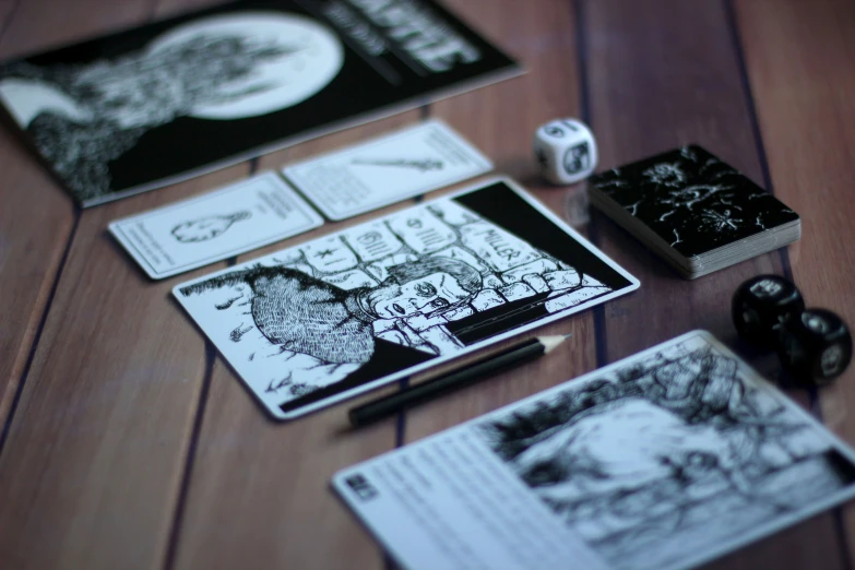 several notebooks on top of each other with dice laying around