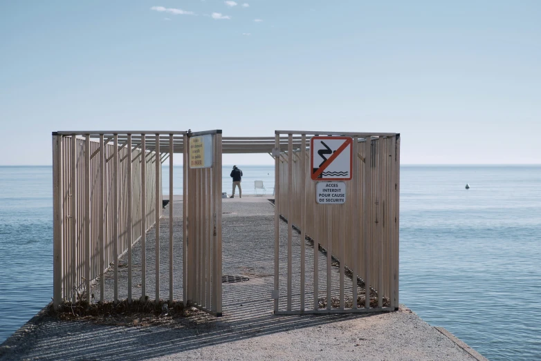 a gate that extends into the water from an island