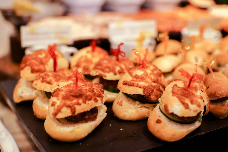 mini sandwiches that have been covered with some type of toppings