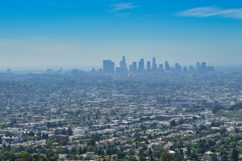 an aerial view of the city with many trees in it