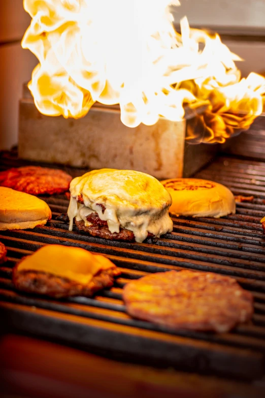 hamburgers and burger patties cooking on a grill