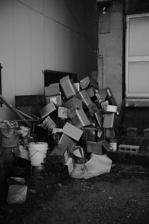 a pile of boxes outside a building in the day