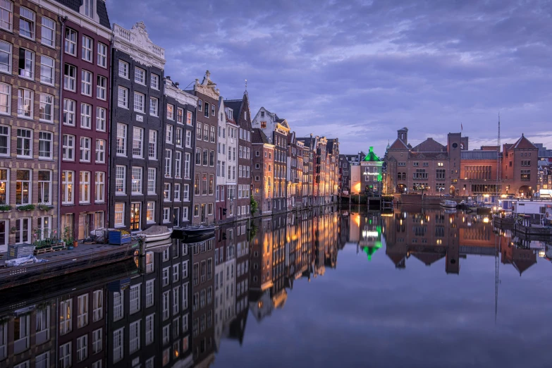 a group of buildings that are reflecting in the water