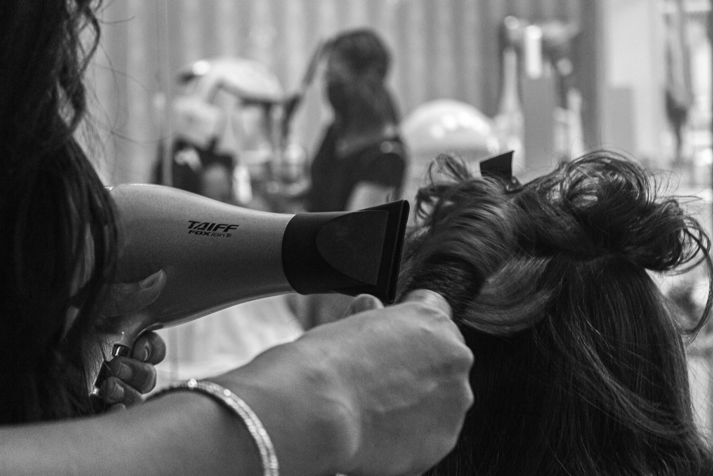 an image of a woman getting her hair cut