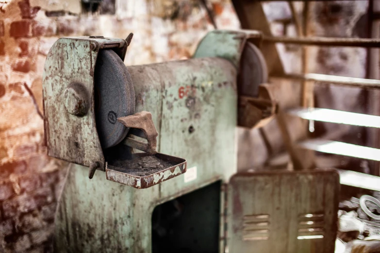 an old, rusted paper mill sitting against a brick wall