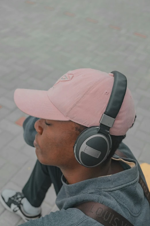 a person wearing pink hat and black headphones