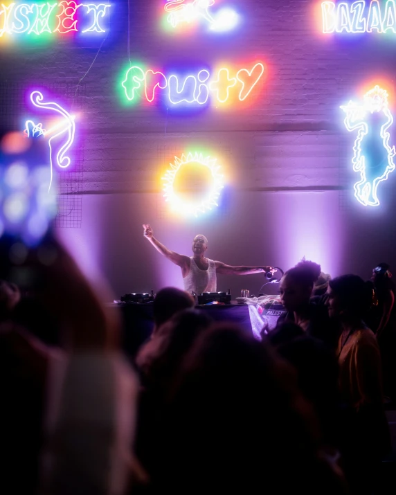 man in front of colorful neon signs and lights