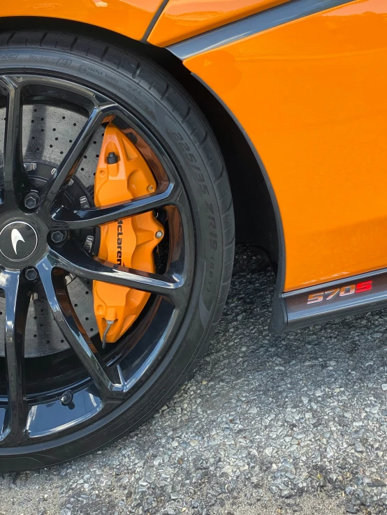 the orange sports car has been painted in a metallic color