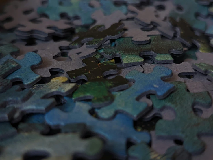a pile of puzzle pieces on top of each other
