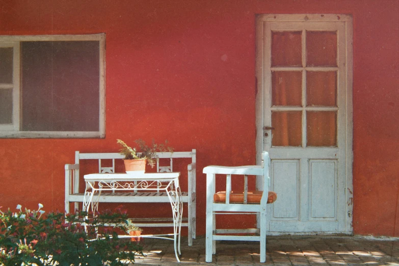 a white chair and table sitting in front of a door