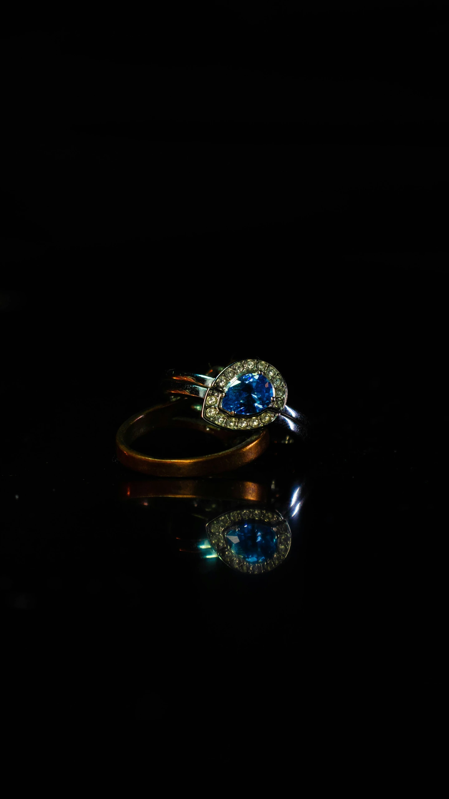 a dark room with black walls and some blue diamond rings