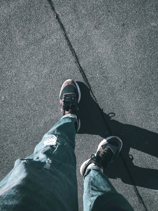 the feet of two people on a pavement