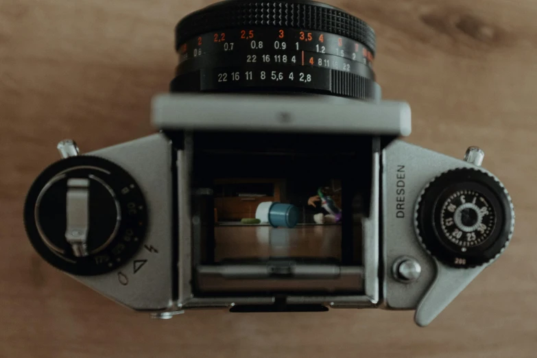 an old fashioned camera showing the reflection of another po