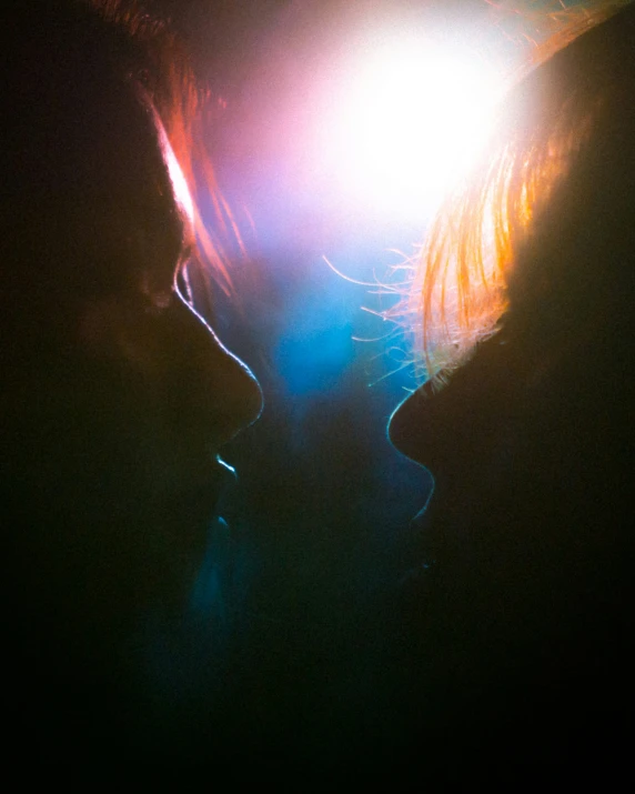 two people with their eyes covered by a blue light